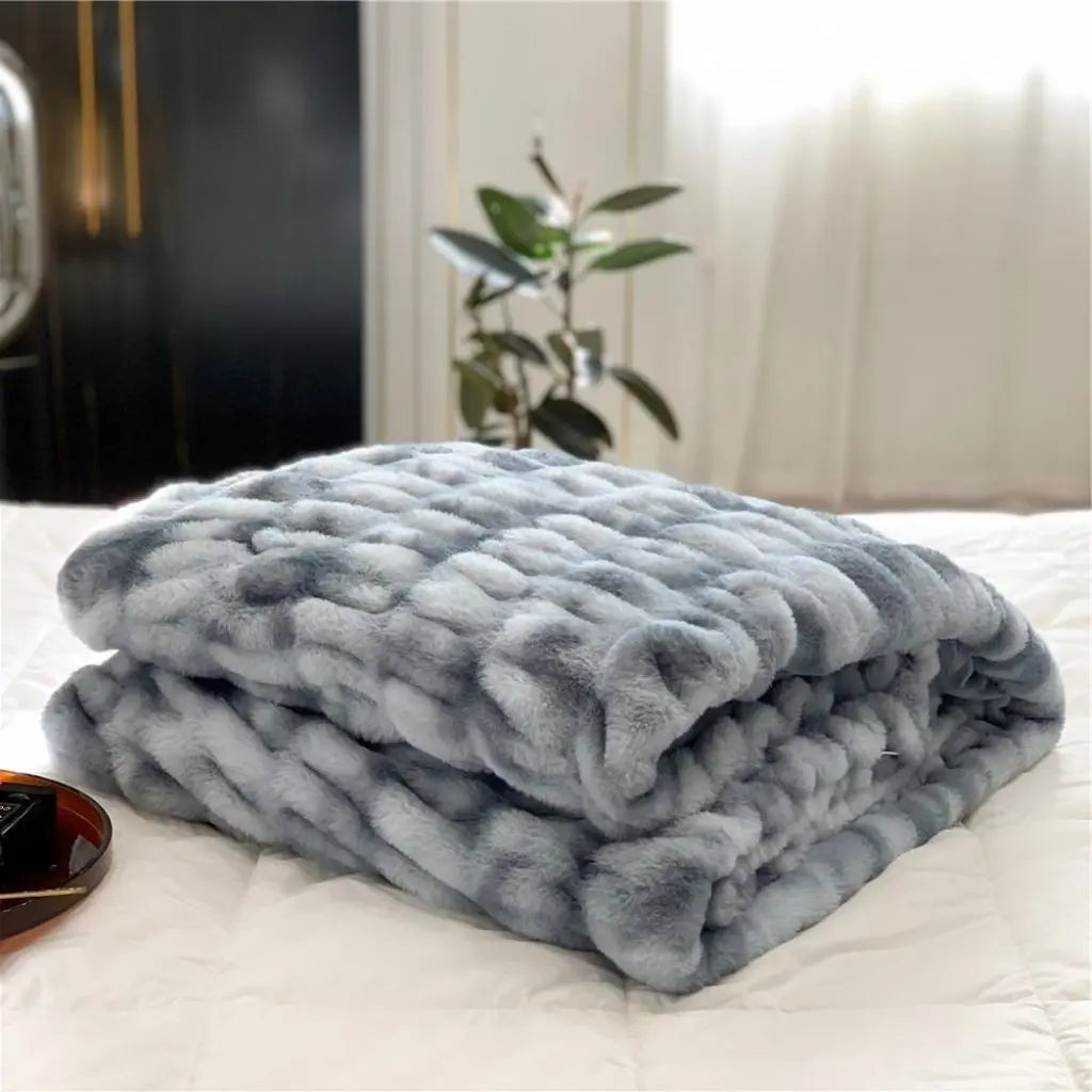 Faux fur throw blanket with bubble texture draped on modern sofa