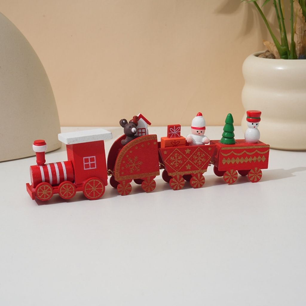 Wooden Christmas train with hand painted festive carts and miniature trees on white background