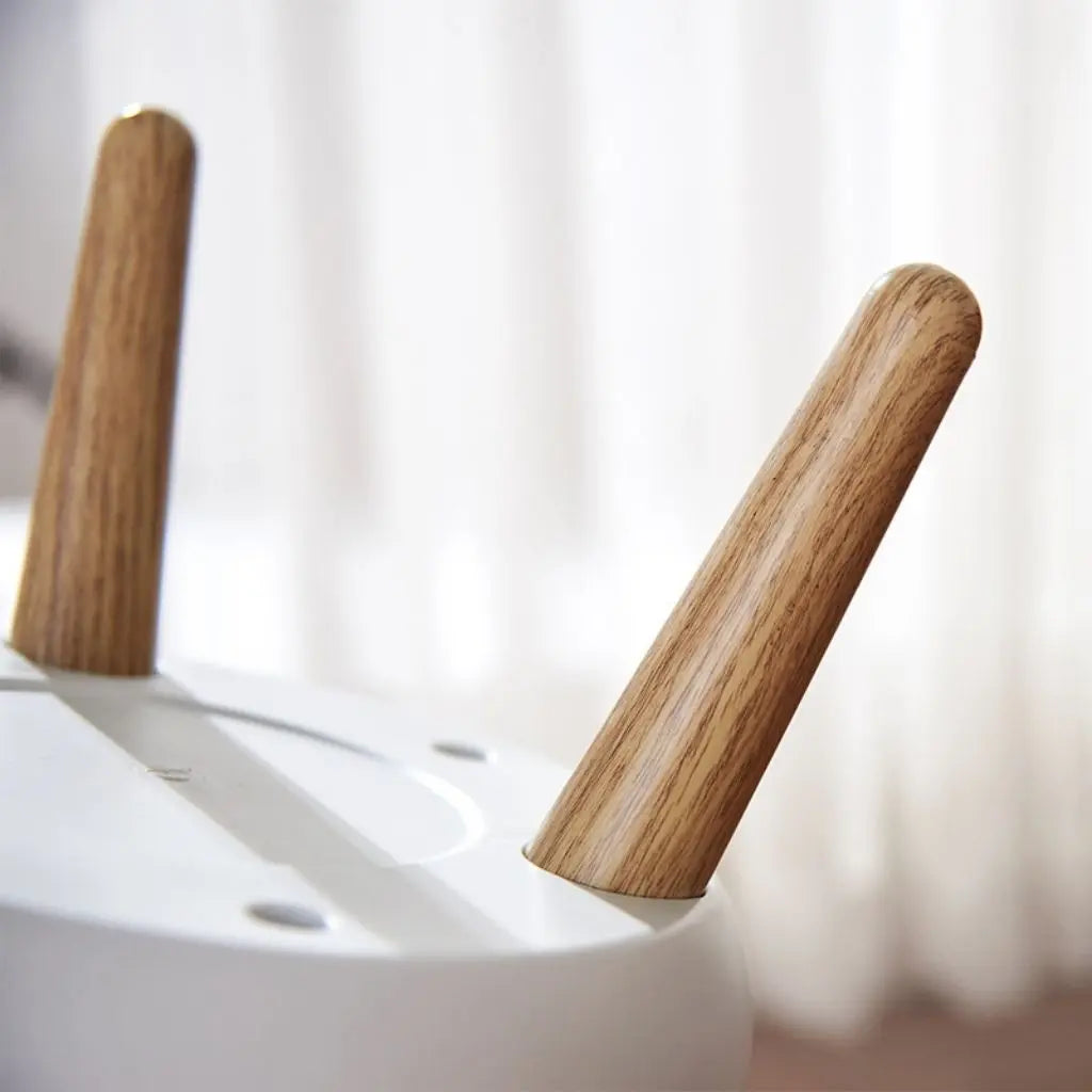 Minimalist garbage bin with smooth PP plastic body and elegant wooden legs for home decor