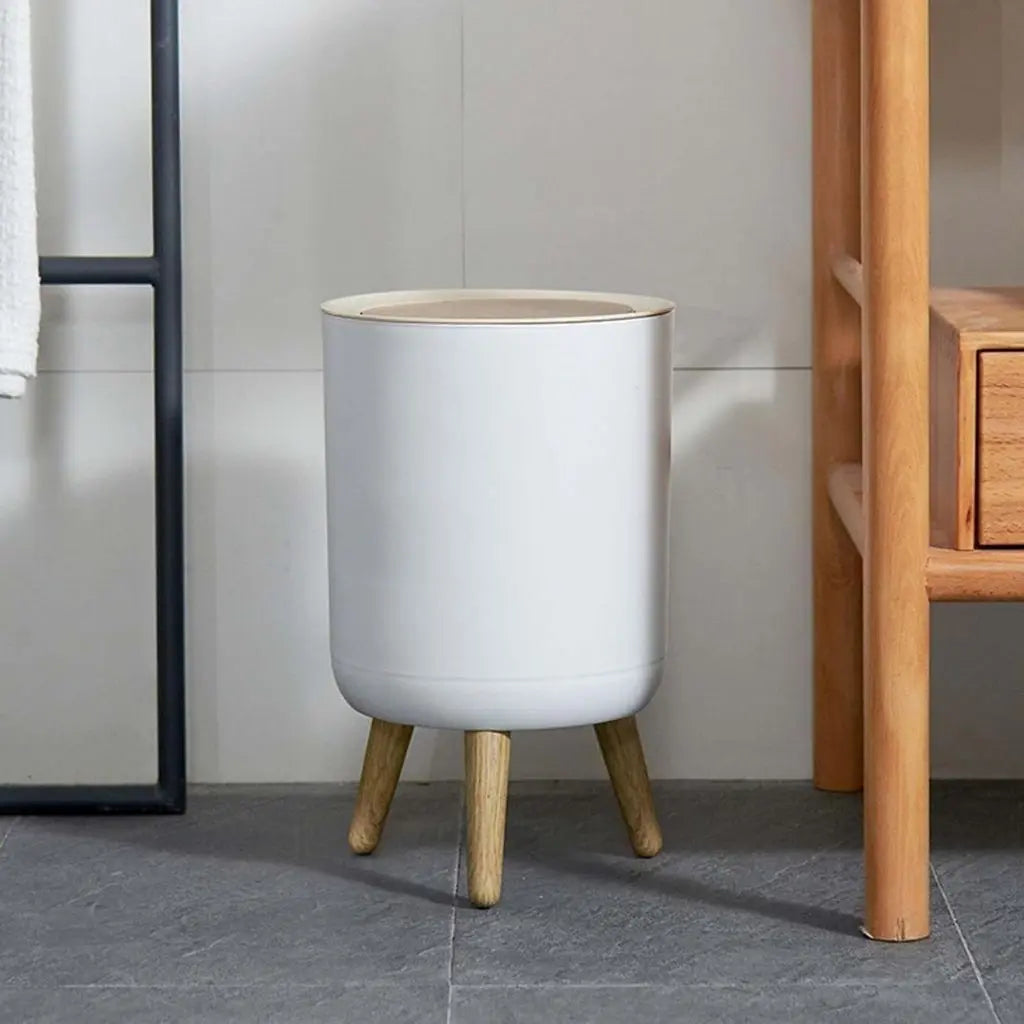 Compact cylindrical waste bin featuring hands free push top lid and natural wood grain base