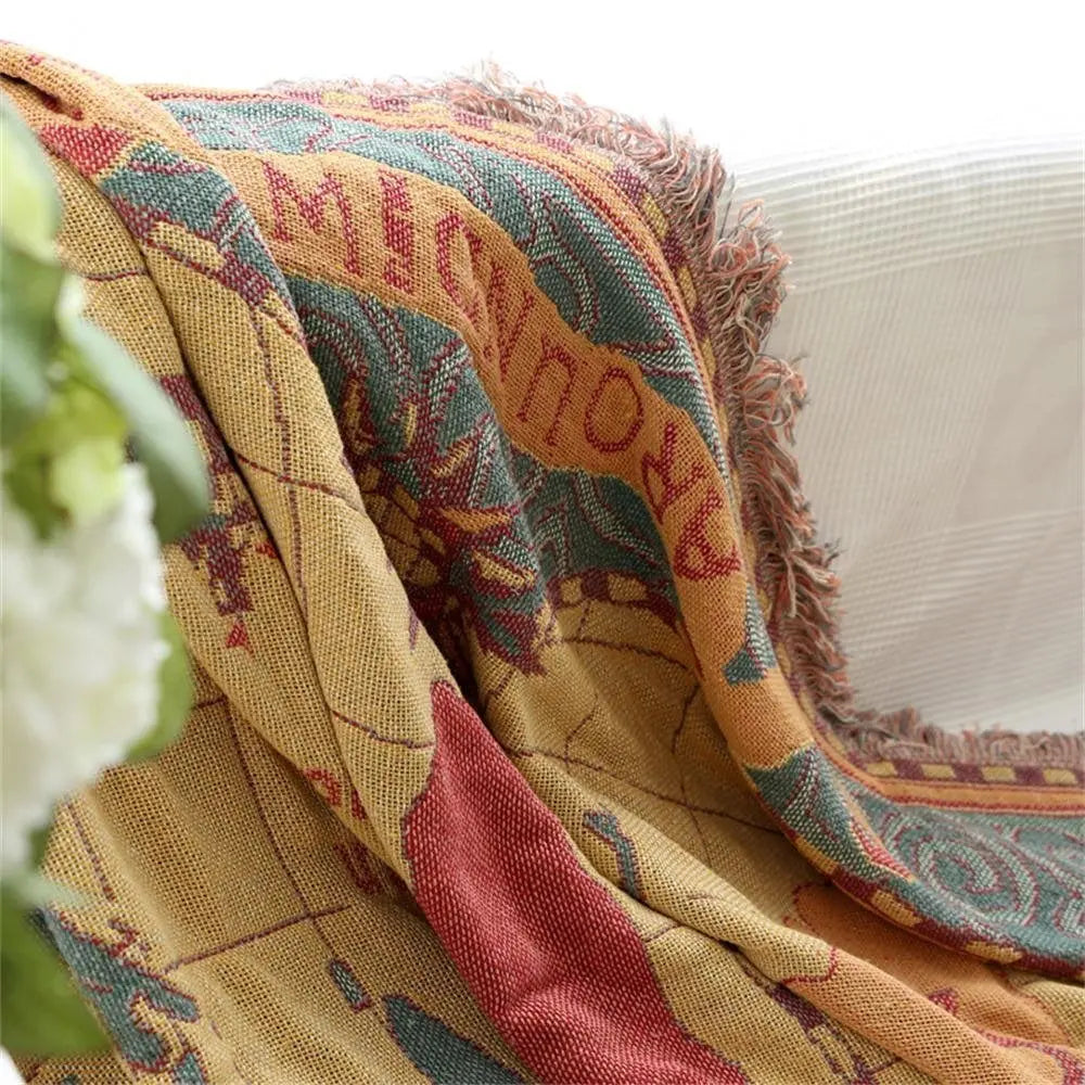 Decorative blanket with intricate patterns draped over a surface