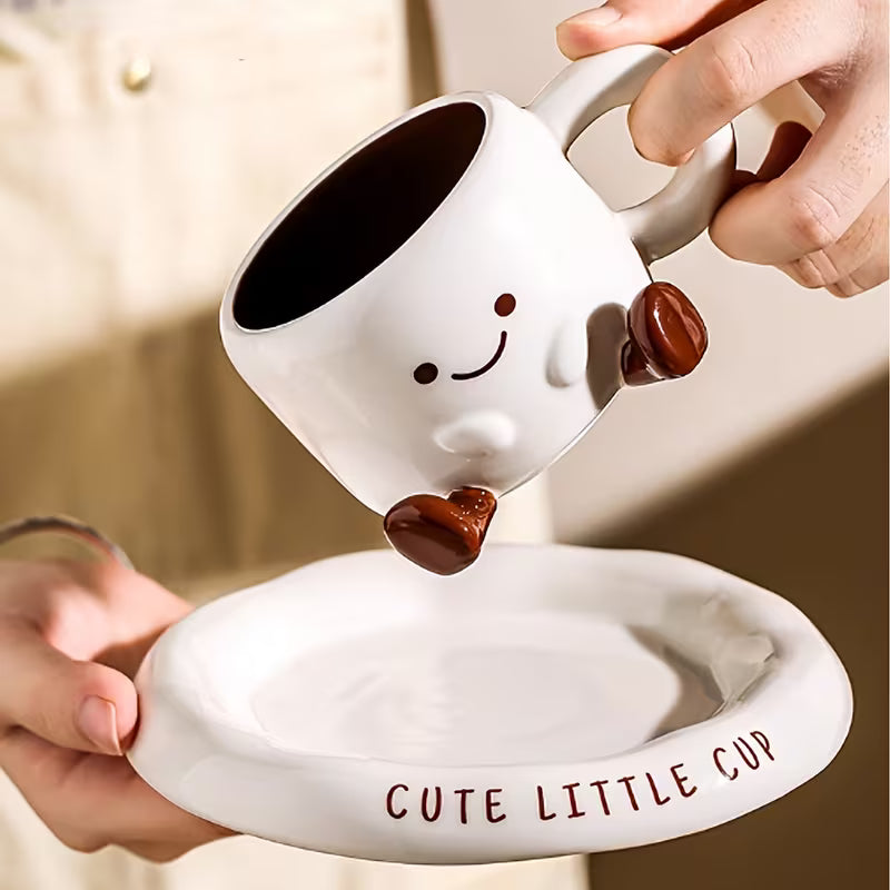 Ceramic cup with a face design being filled with chocolate by another cup, on a matching saucer.