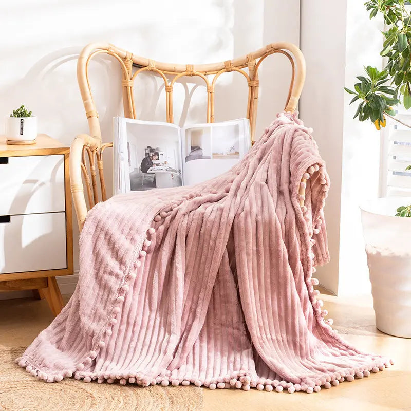 Velvet pom throw with textured fringe bringing personality to cozy home styling