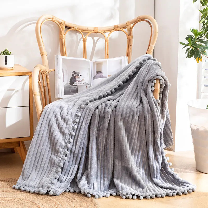 Pom edge throw with striped velvet flannel design for versatile home comfort