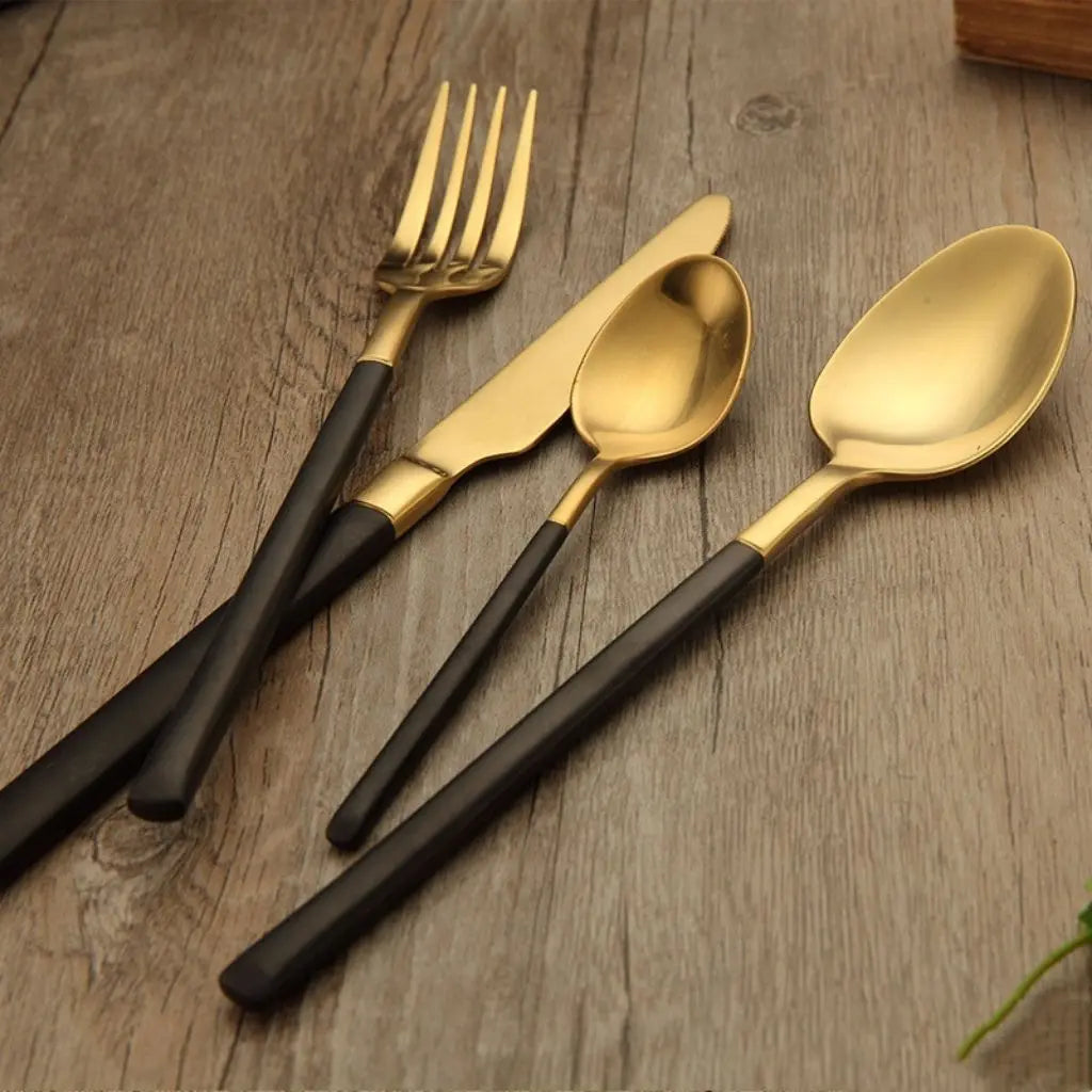 Durable stainless steel cutlery with lustrous gold coating and comfortable black handle design