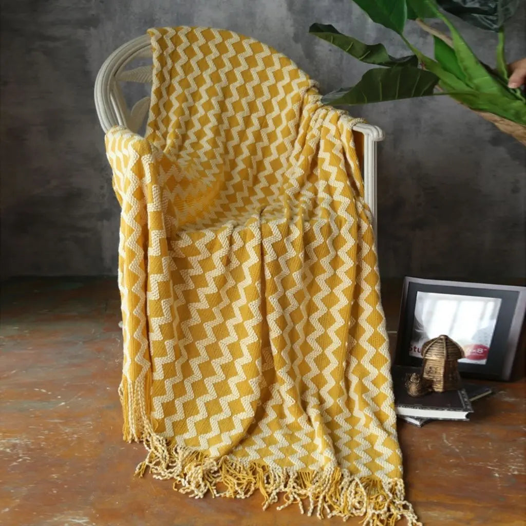 Textured chenille throw with geometric knit design and fringe edges for layering
