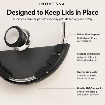 Inovessa black pot lid cradle shown on a light beige background with callout text explaining its raised side supports, stepped grip design, curved lid cradle, and durable ABS construction.