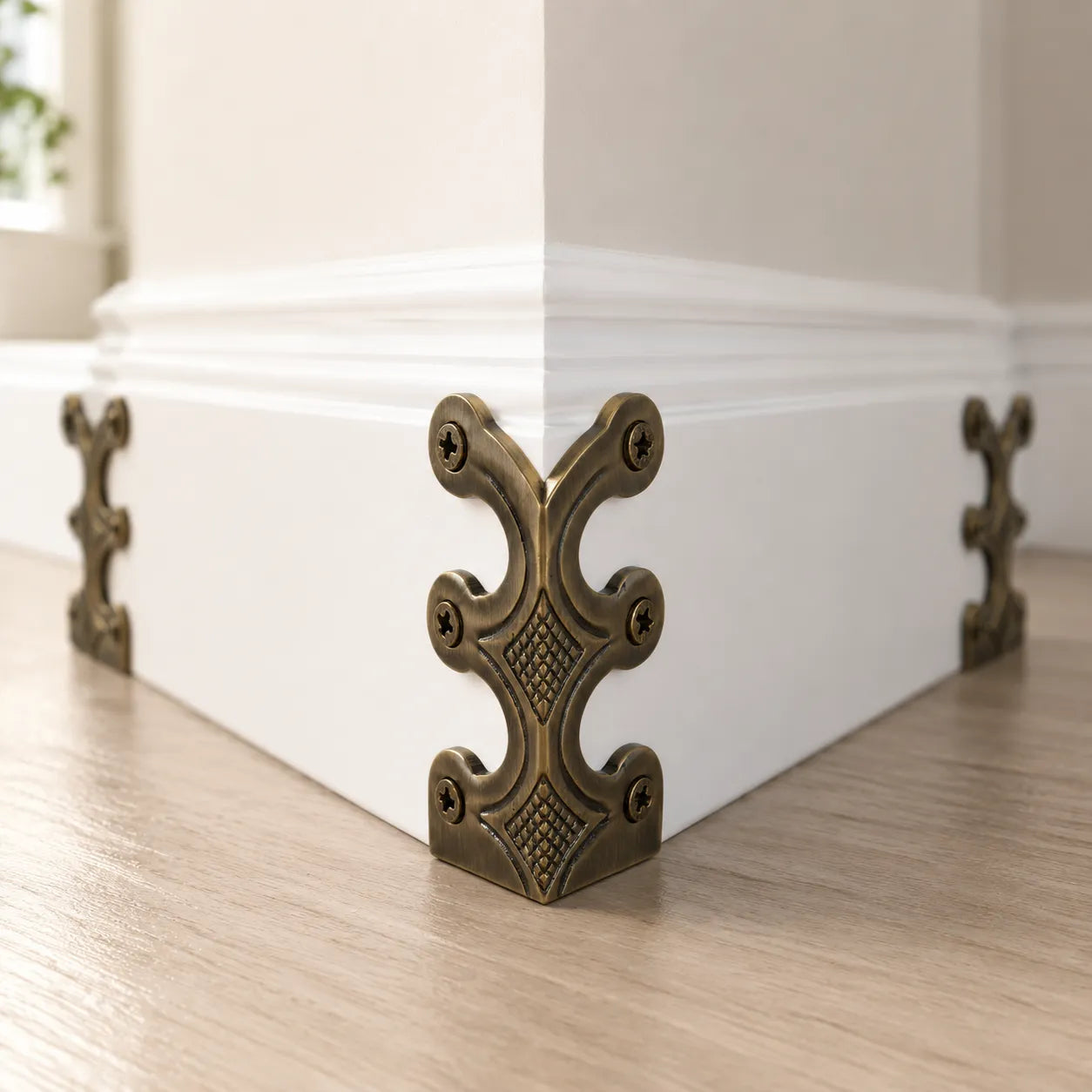 Decorative corner bracket on a white baseboard with a neutral background