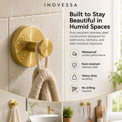 Gold towel hook on a tiled wall with Inovessa branding and product features.