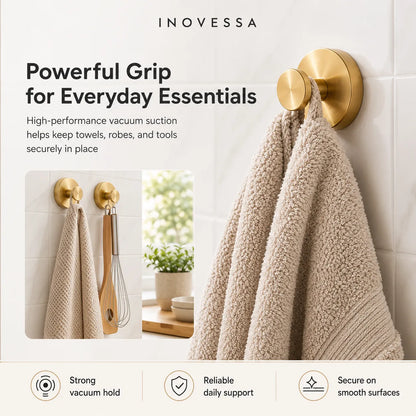 Gold towel hook with towels on a tiled wall, featuring Inovessa branding.