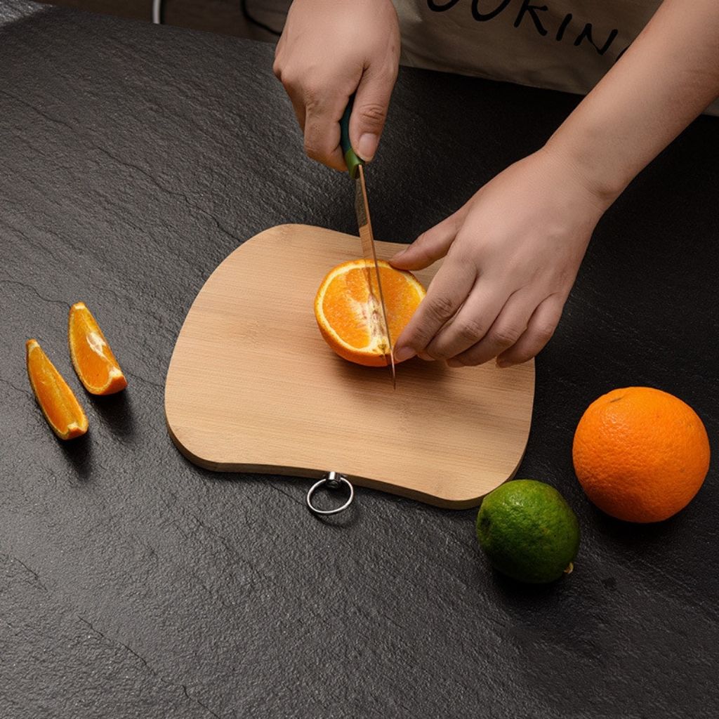 Moisture-resistant bamboo cutting board with compact 25x25cm design and convenient hanging storage ring