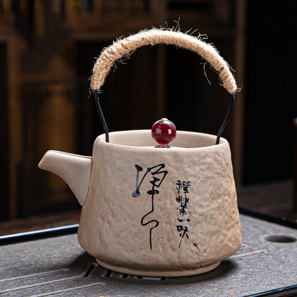 Textured ceramic teapot with bold red lid accent and ancient pottery finish ideal for tea collection display