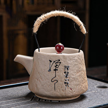 Textured ceramic teapot with bold red lid accent and ancient pottery finish ideal for tea collection display
