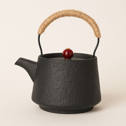 Handcrafted ceramic teapot with rope-wrapped beam handle and red lid accent for authentic gongfu tea brewing