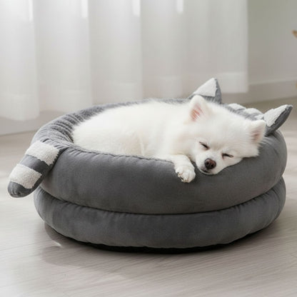 Round cat bed with decorative ear accents and plush gray fabric