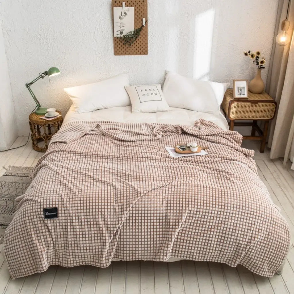 Close-up view of smooth polyester blanket fabric showing soft skin-friendly texture and weave
