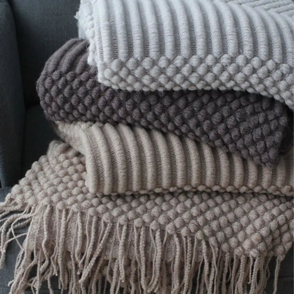 Decorative textured throw blanket with fringe trim for versatile home comfort