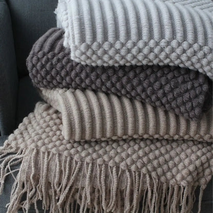 Decorative textured throw blanket with fringe trim for versatile home comfort
