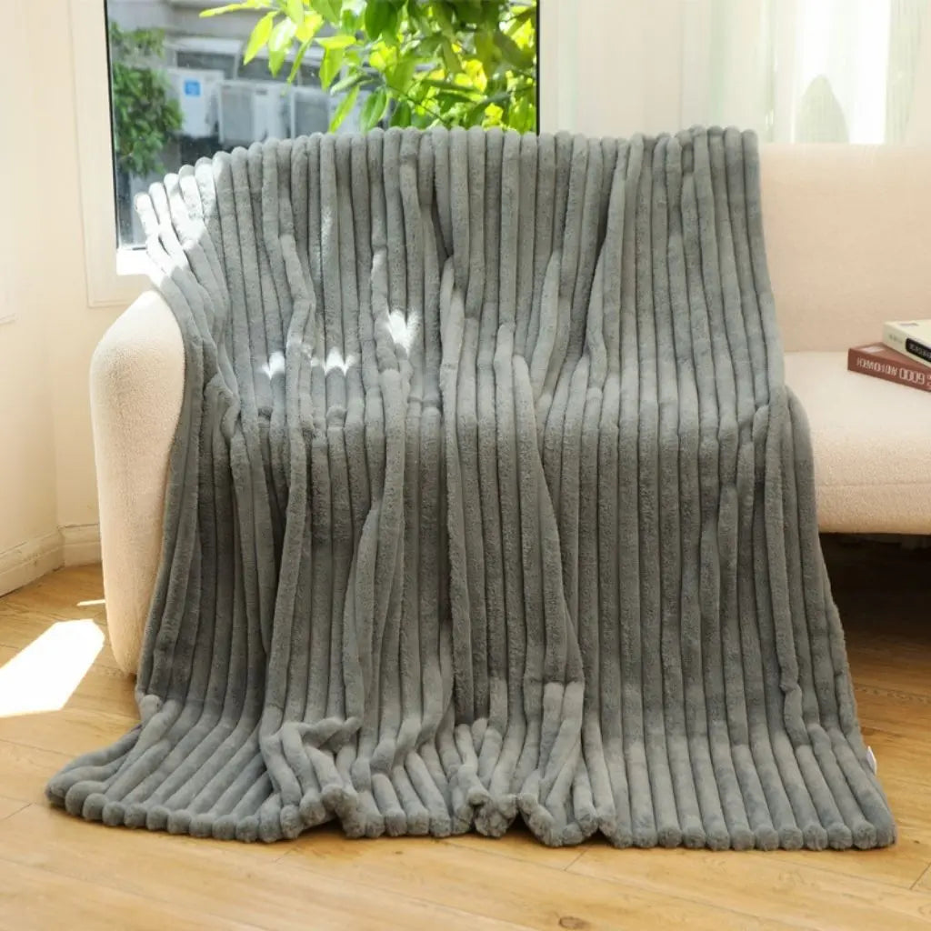 Velvety jacquard blanket with striped pattern for insulating warmth and comfort