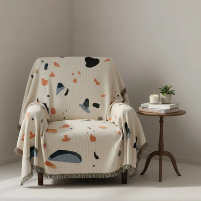 Decorative blanket with abstract starry sky pattern in warm shell tones for sofa or bed