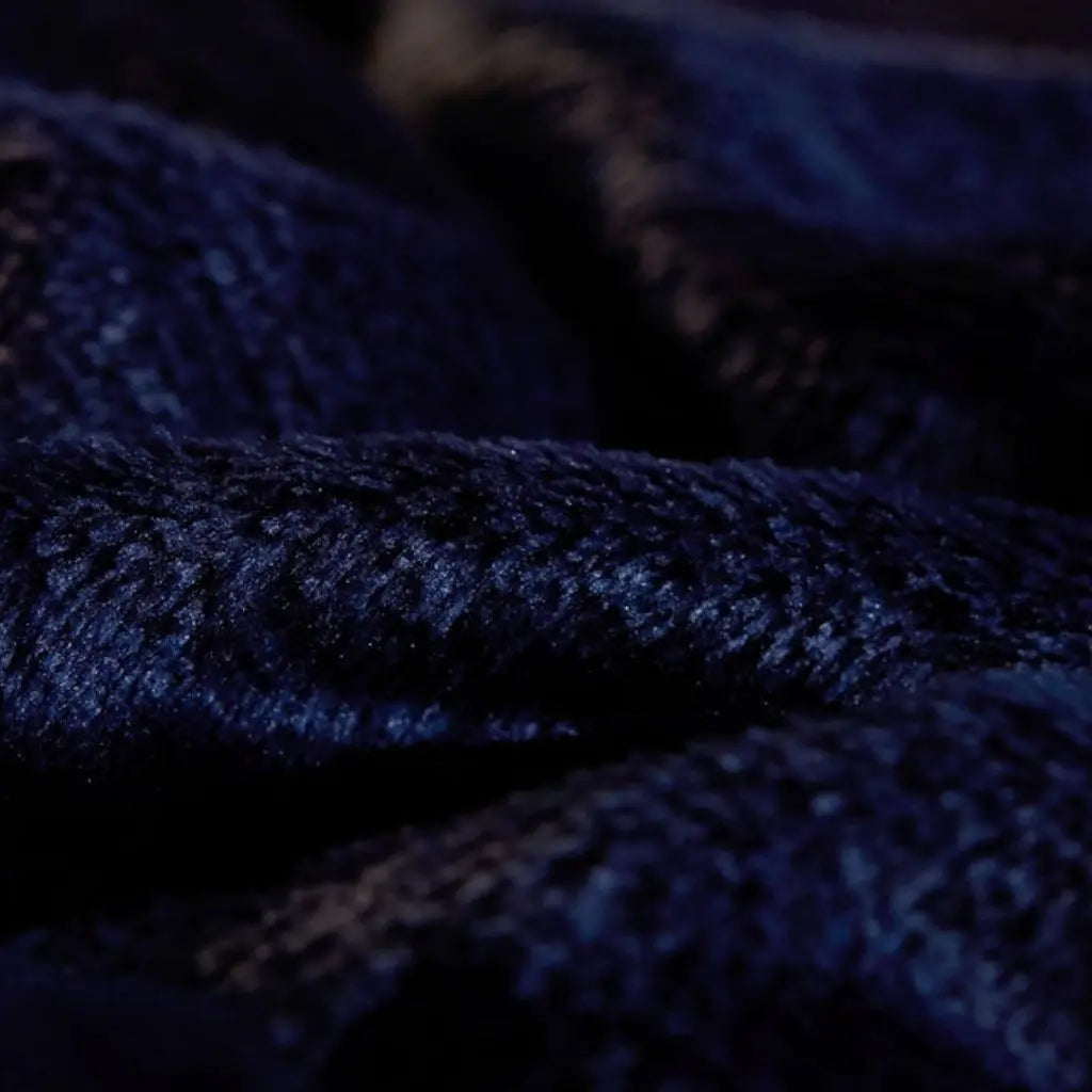 Dual sided throw blanket featuring smooth flannel exterior and plush sherpa interior texture