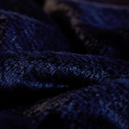 Dual sided throw blanket featuring smooth flannel exterior and plush sherpa interior texture