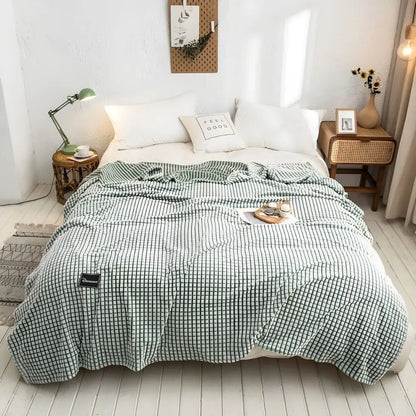 Soft polyester throw blanket draped on sofa for cozy living room comfort and relaxation