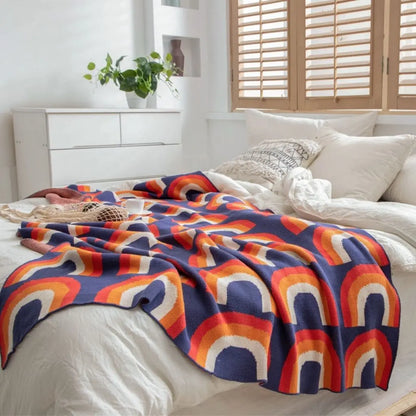 Bohemian rainbow knit throw blanket with bold multicolor pattern for interior styling