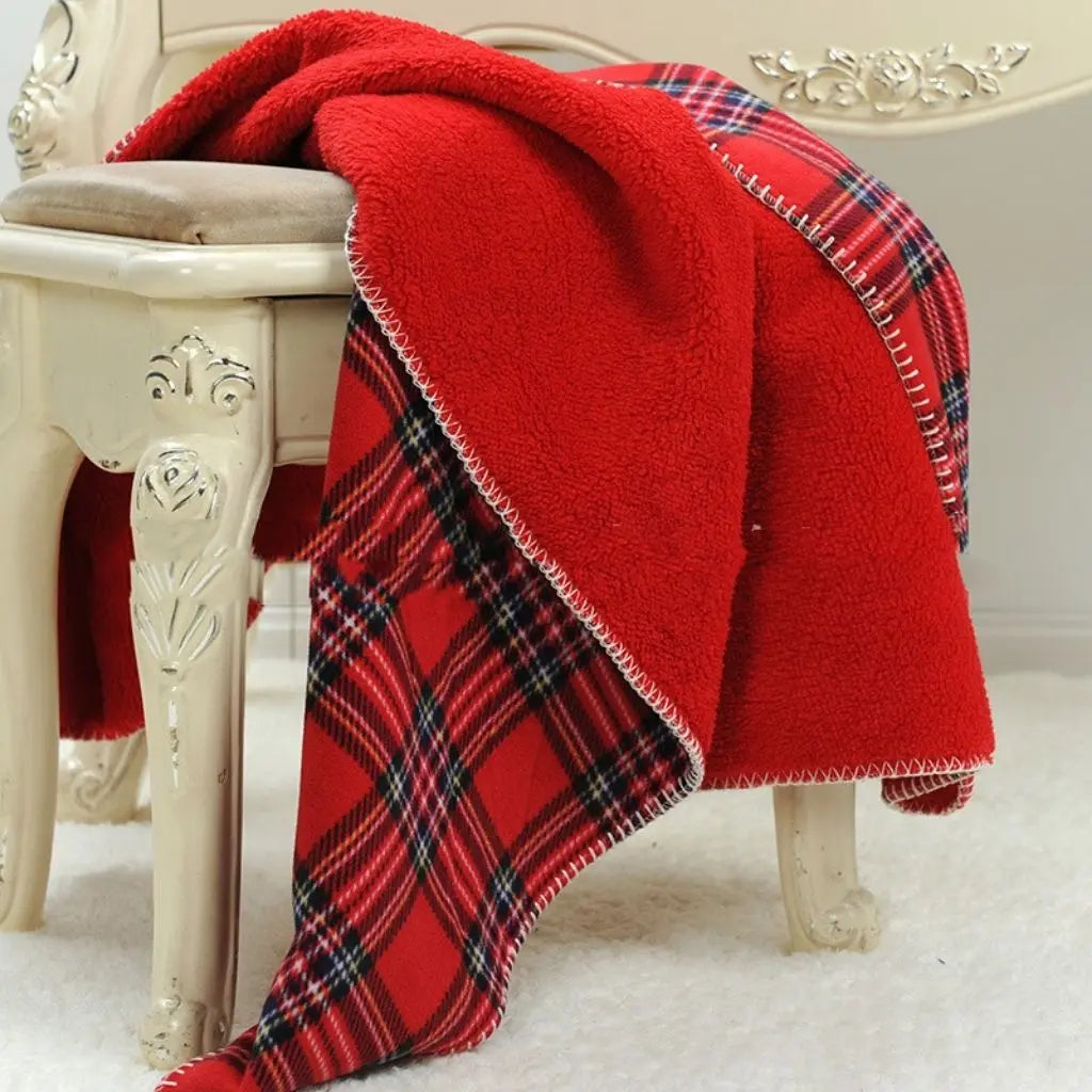 Checkered fleece blanket in red plaid design with warm flannel texture

