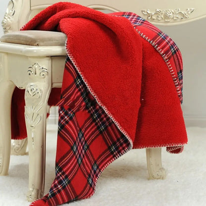 Checkered fleece blanket in red plaid design with warm flannel texture

