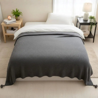 Durable acrylic knit throw with decorative tassel border for home styling