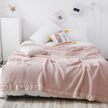 Lightweight waffle weave quilt with delicate lace edge detail for home decor

