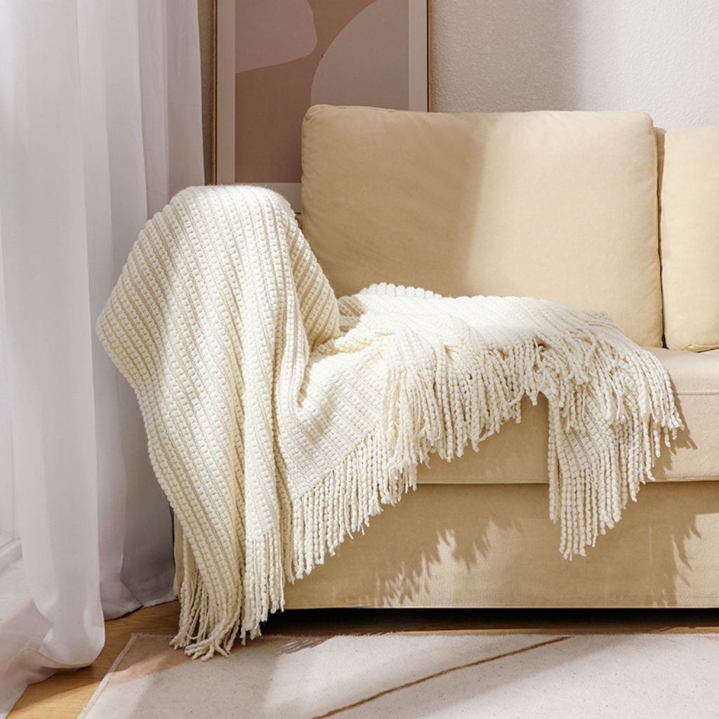 Soft chenille throw blanket with long fringe edges in solid color for sofa and bed use