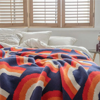 Multicolor knitted throw blanket with vibrant rainbow arch design made from cotton