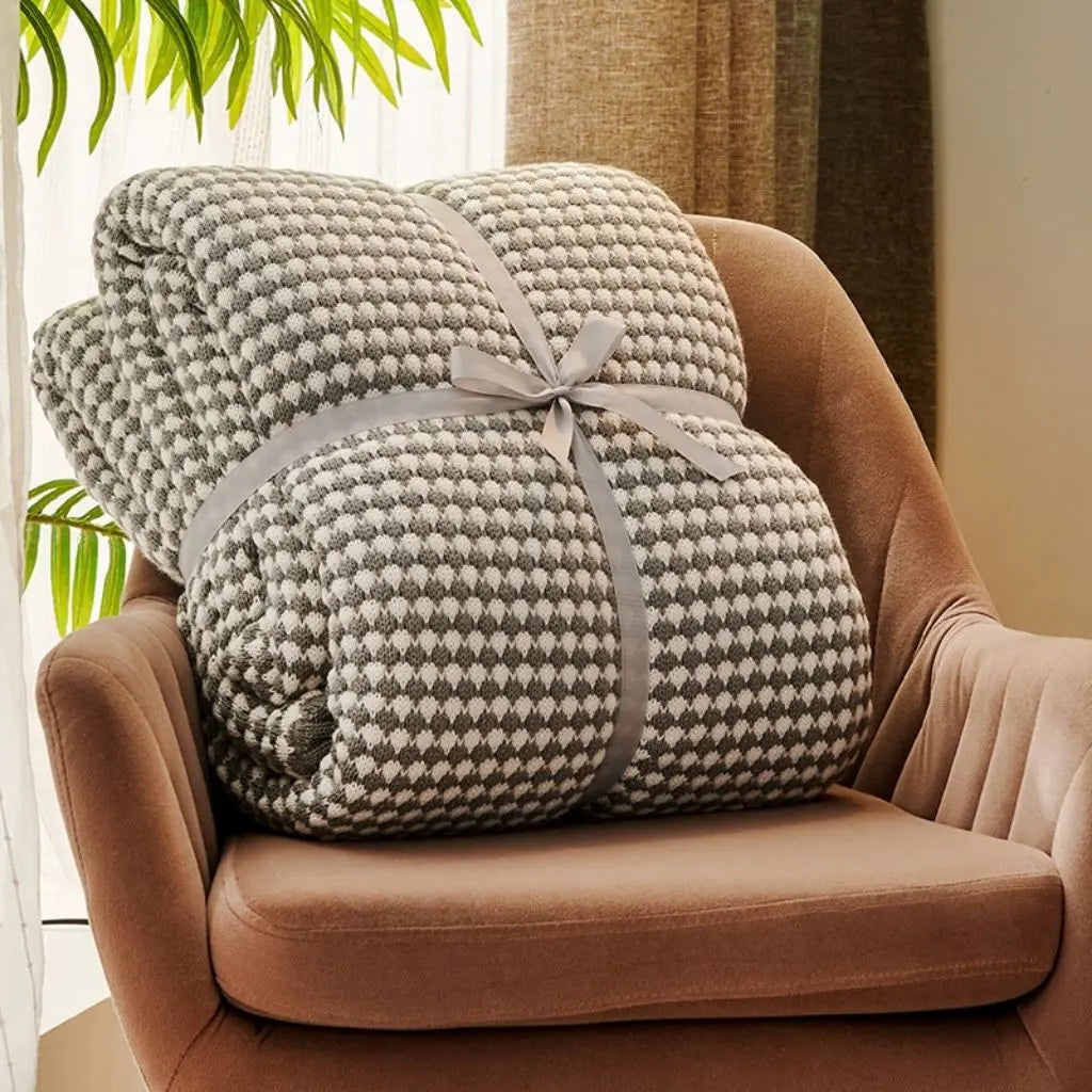 Neutral colored wool throw blanket with modern weave pattern for versatile home comfort