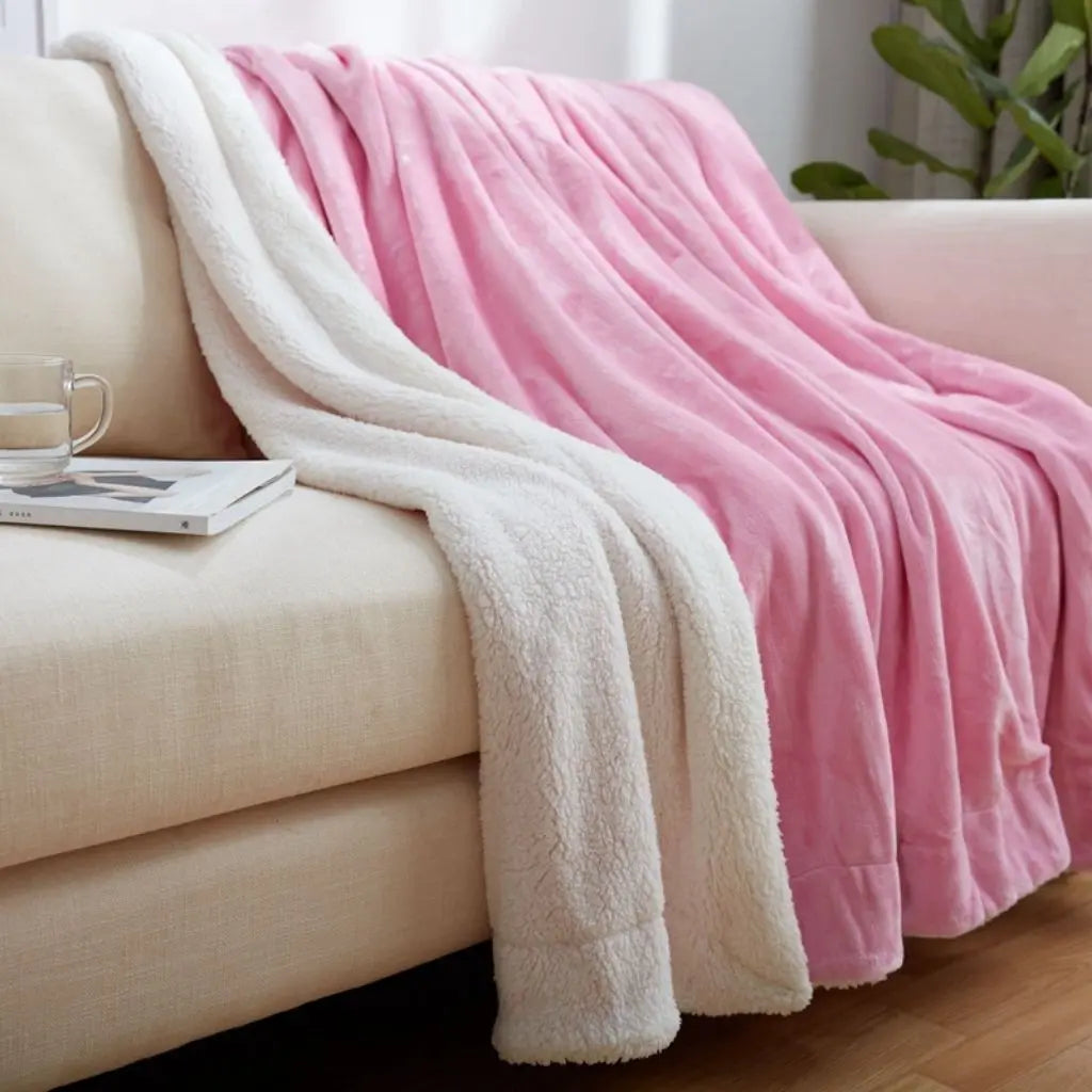 Reversible plush sherpa fleece blanket with warm coral velvet and soft cashmere sides
