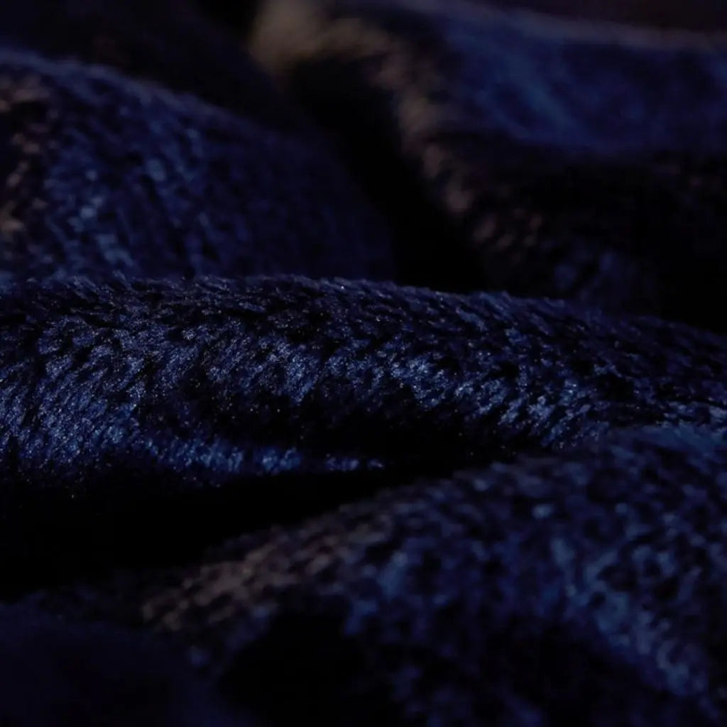 Sherpa backed flannel throw blanket designed for chairs sofas and comfortable lounging spaces