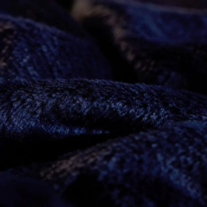 Sherpa backed flannel throw blanket designed for chairs sofas and comfortable lounging spaces