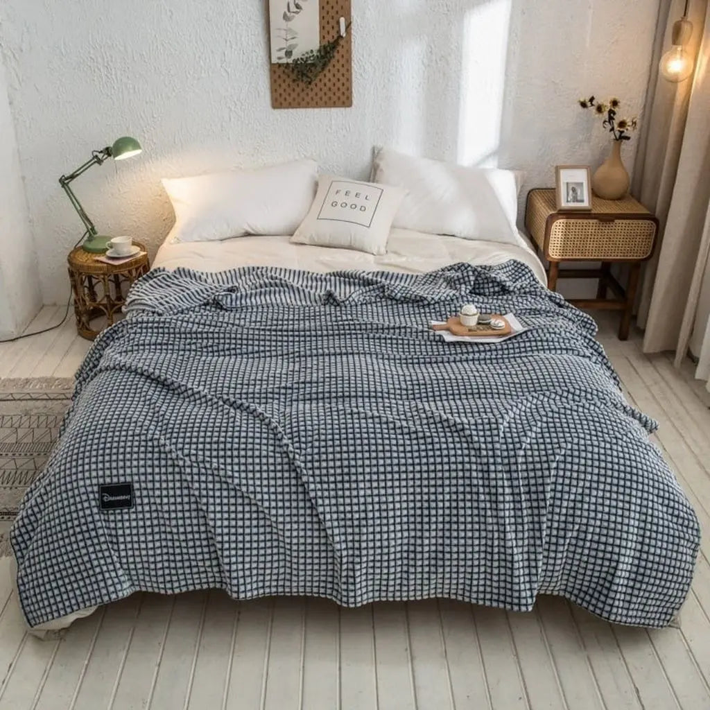 Folded lightweight polyester blanket showing compact storage and portable comfort design