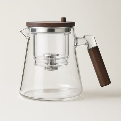 Clear glass coffee pot with wooden lid and handle on a light background