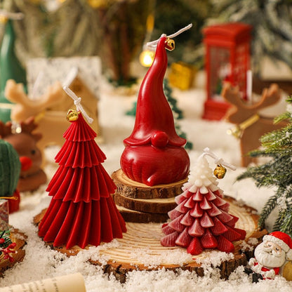 Christmas tree shaped candle with multiple tiers and decorative cord bell on tabletop