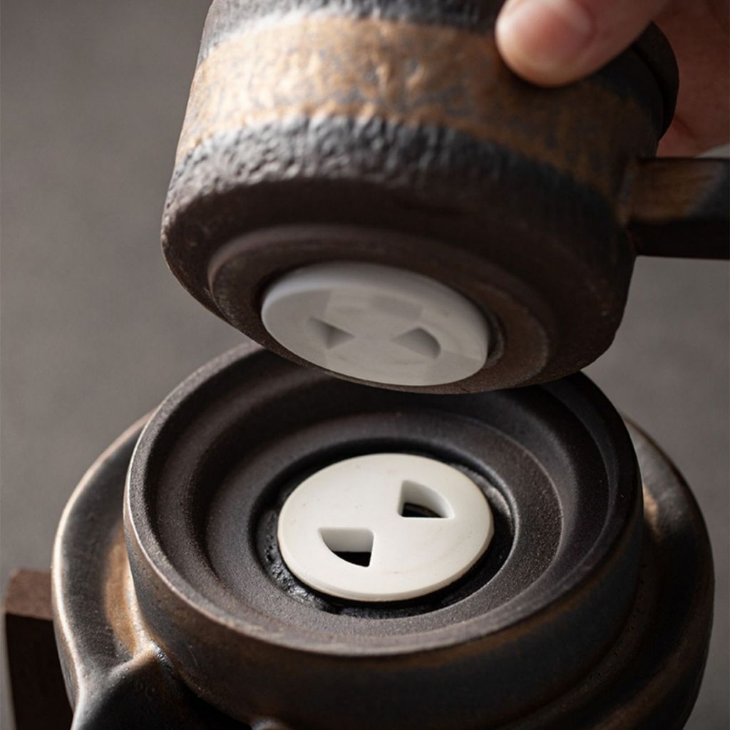 Handcrafted ceramic teapot with gilded iron glaze and bamboo handle for loose leaf tea brewing
