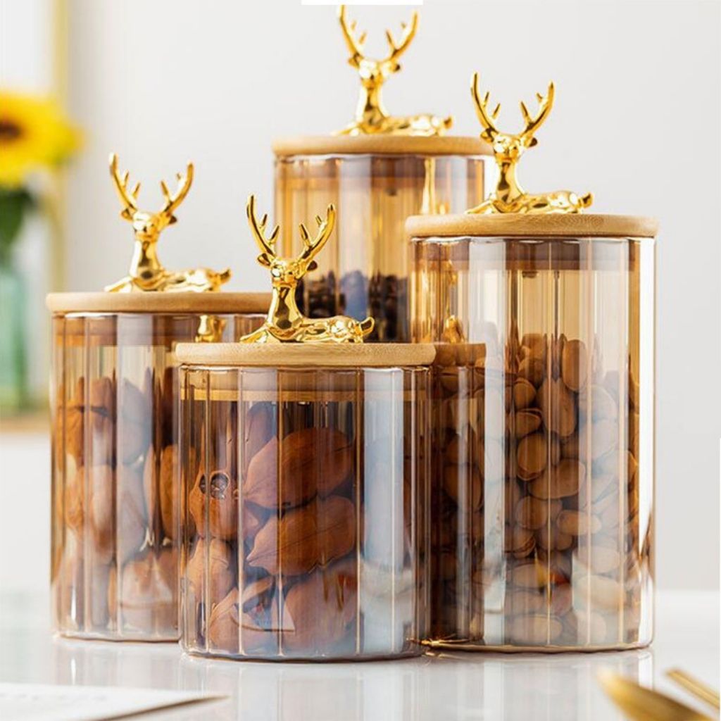 Transparent amber jar with linear stripe detail and wildlife themed lid