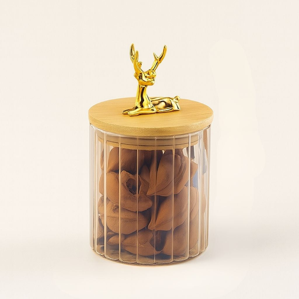 Round glass storage vessel with vertical texture and elk sculpture lid