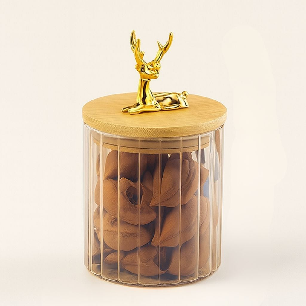 Amber glass container with striped body and three dimensional elk lid accent