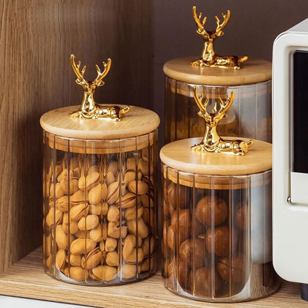 Vertical stripe glass container with sculpted elk handle in warm amber tone