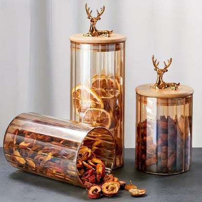 Round amber glass storage jar featuring decorative elk lid topper