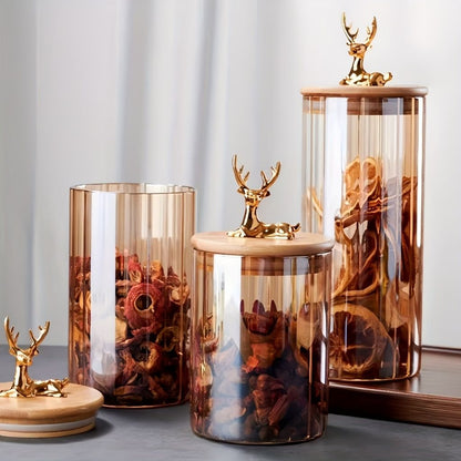 Glass canister with ribbed vertical design and nature inspired elk lid
