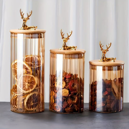 Decorative glass jar with vertical ribbing and elk shaped lid handle