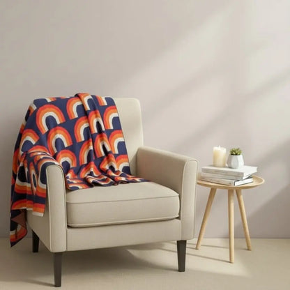 Rainbow knit blanket with multicolor arch pattern made from soft cotton for home decor